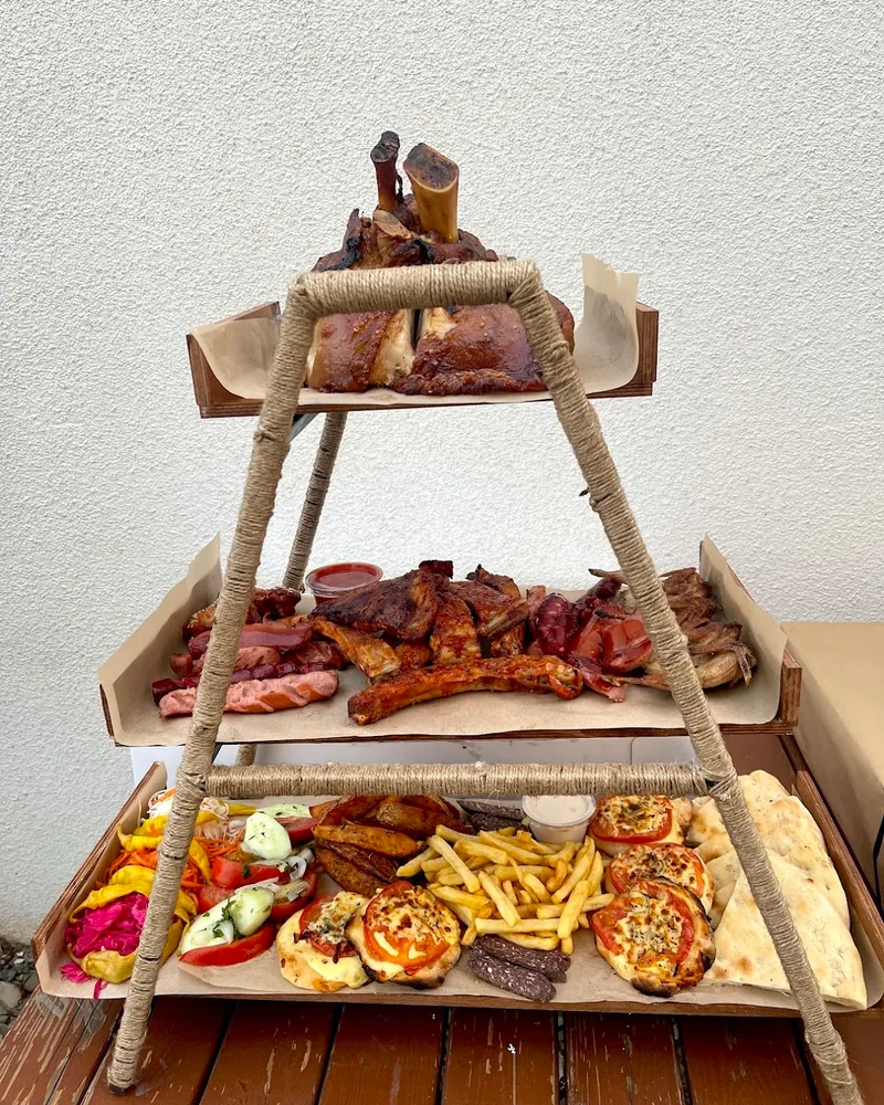 Three-tiered platter of roasted meats, pork knuckle, fries, and appetizers at Dallas Pub