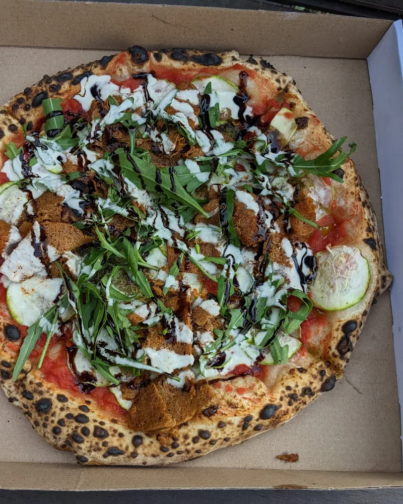 Pizza in a cardboard takeout box at Daner Pizza