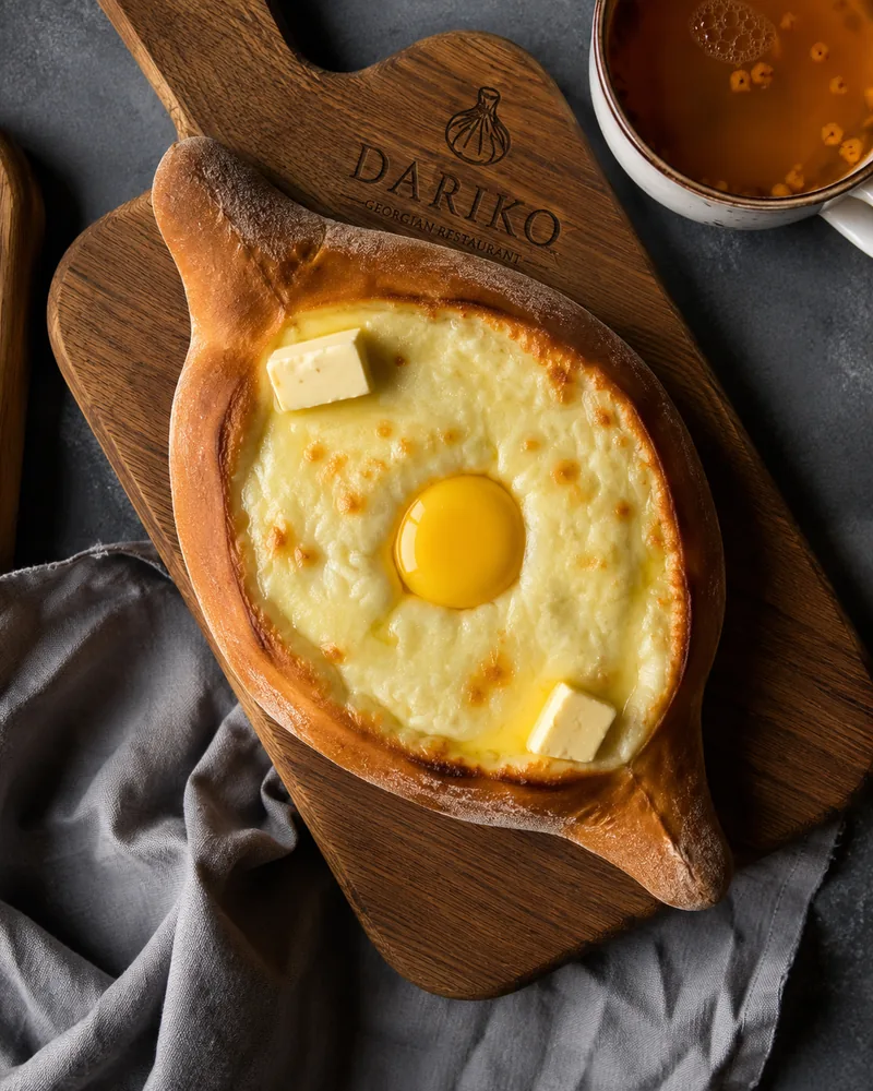 Adjarian khachapuri on a wooden board at Dariko Georgian Restaurant