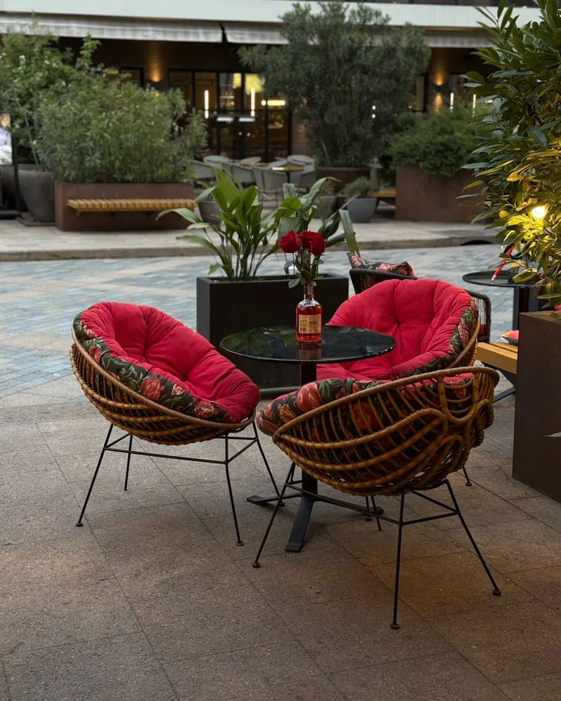 Outdoor patio seating with red cushions at Dariko Georgian Restaurant