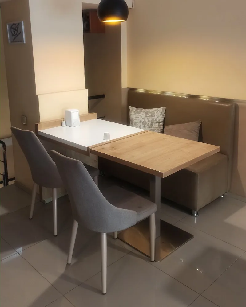 Dining table with banquette seating and chairs at DeGusti