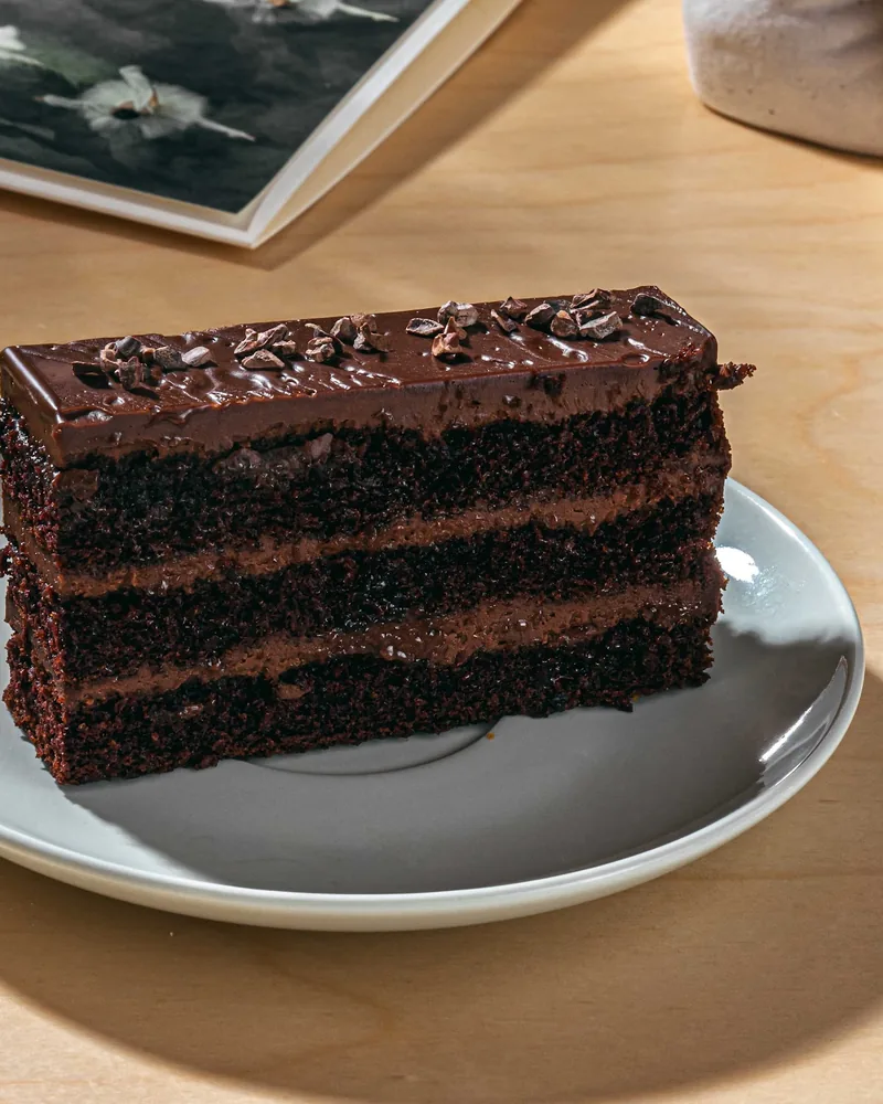 Slice of chocolate layer cake on a plate at Dessert Ballet