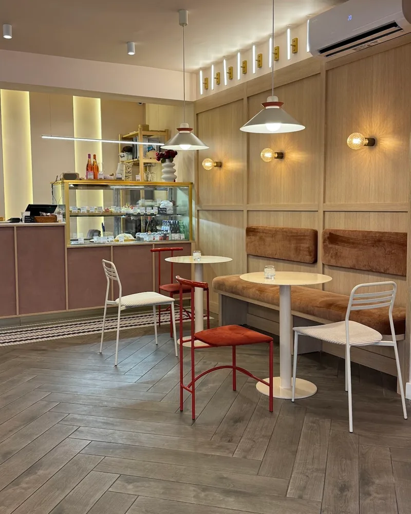 Seating area with wooden wall panelling and the pastry counter at Dessert Ballet