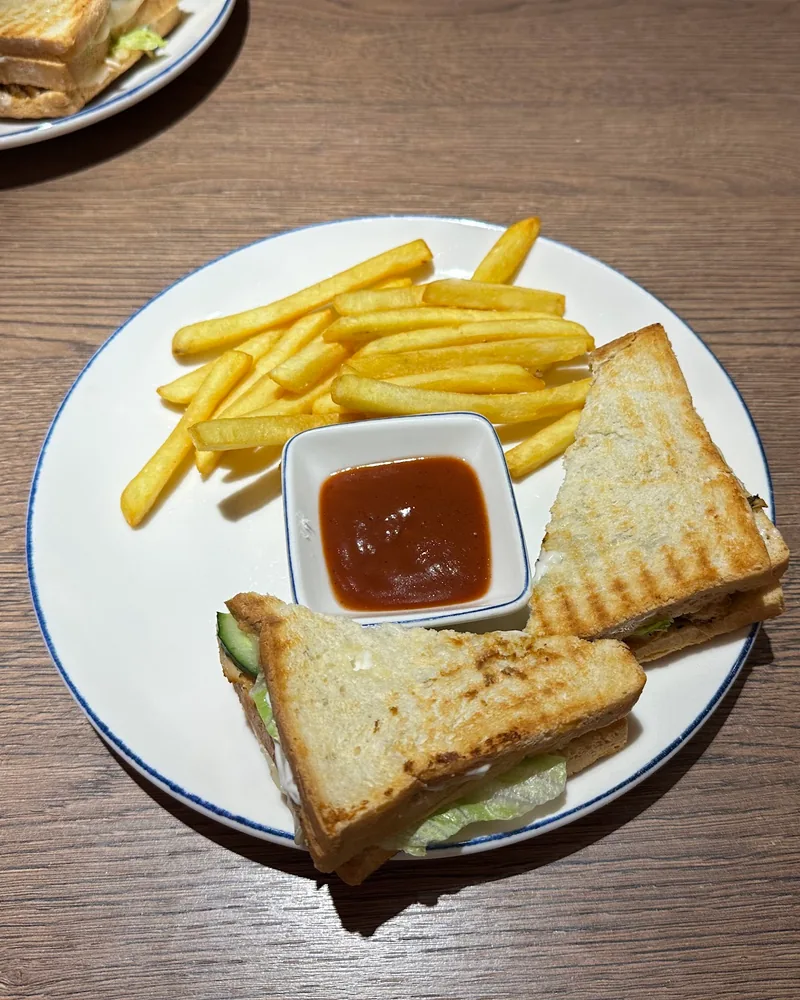 Club sandwich triangles with french fries and ketchup dip at Di Roma