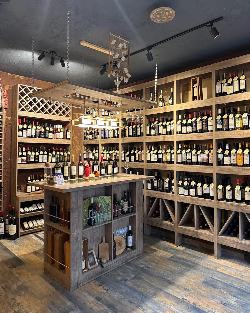 Wine shop interior with tasting island and bottle-lined shelves at Dionysus Wine Shop