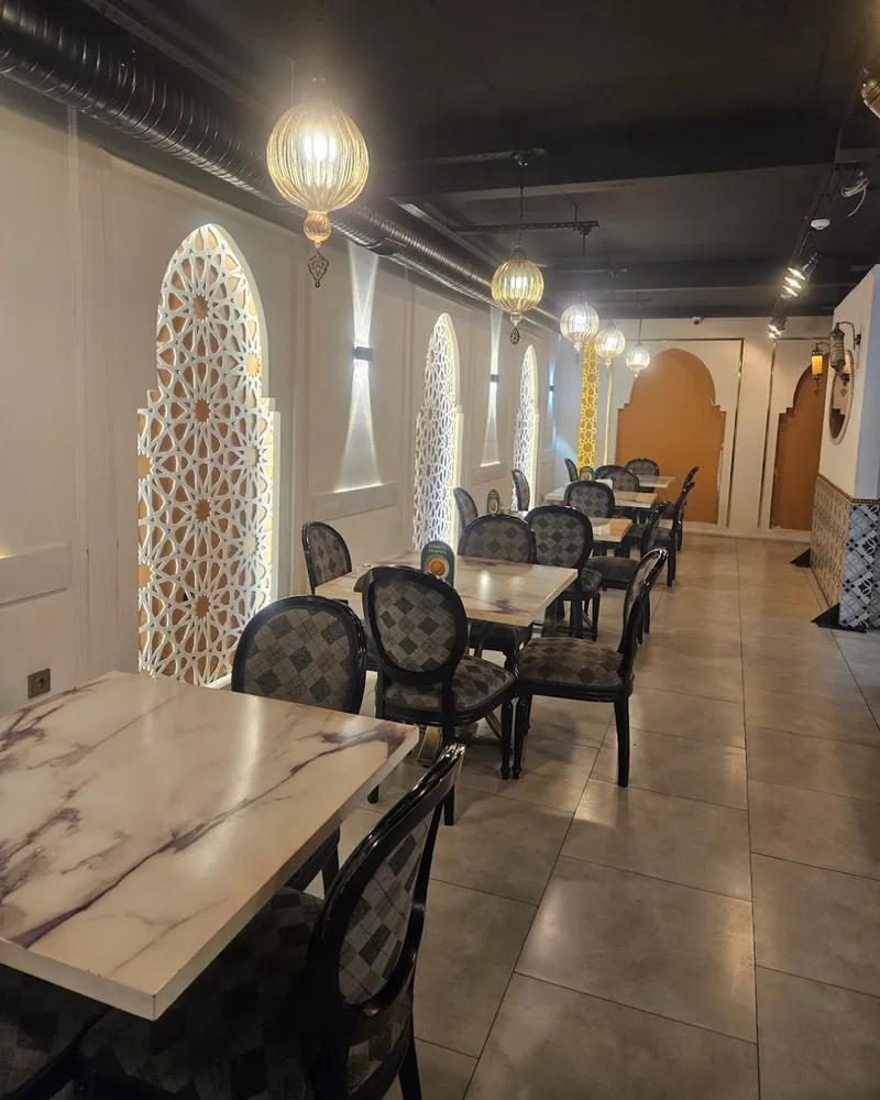 Dining room with arches and globe lanterns at Elit Restaurant