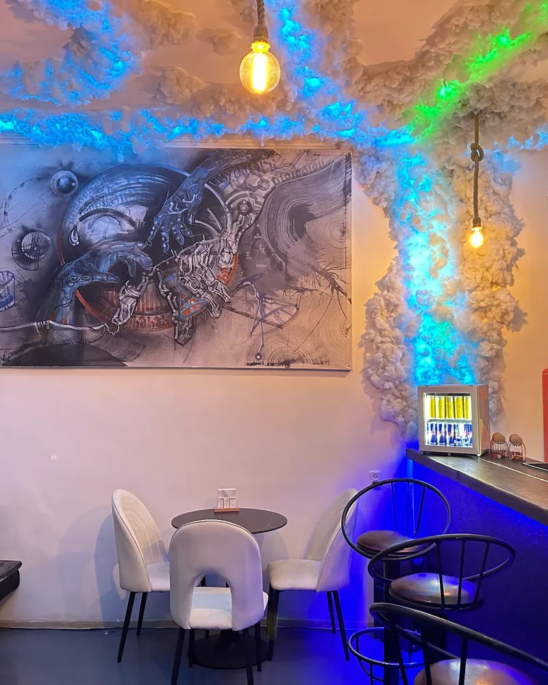 Bar room with a cloud textured ceiling and artwork at Ficus Bar