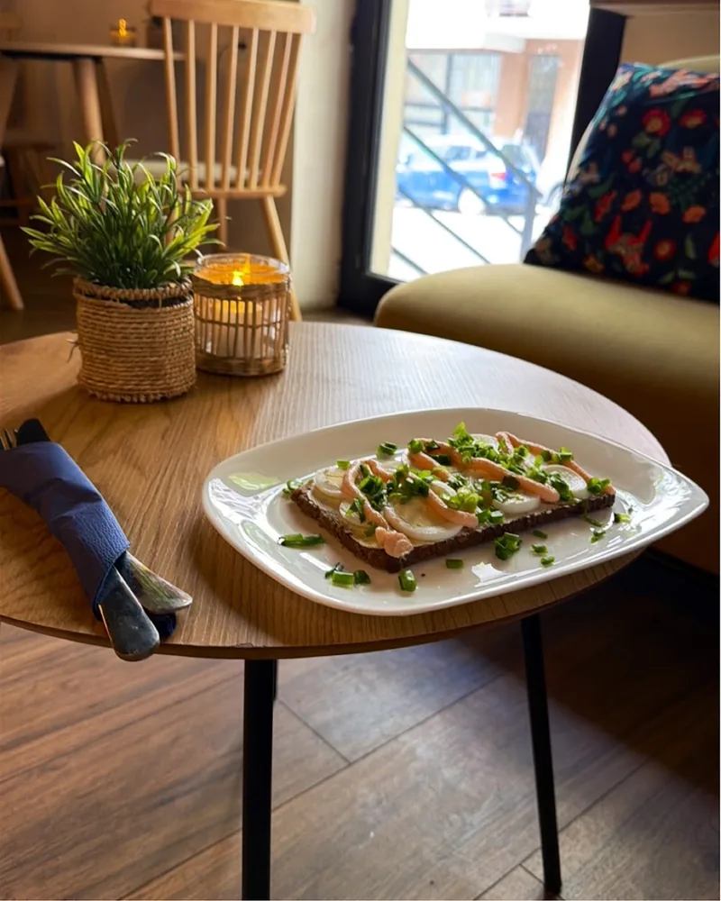 Open-faced sandwich on rye bread with sliced egg and roe spread at Fika Swedish Cafe