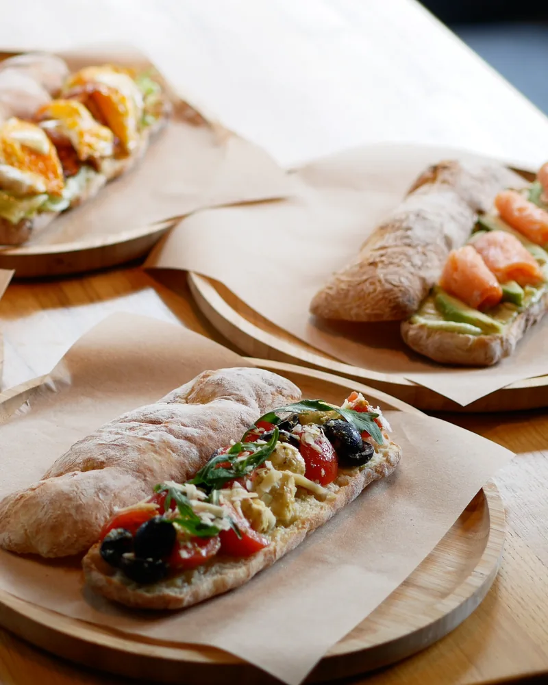 Ciabatta sandwiches on wooden platters at Fiorino