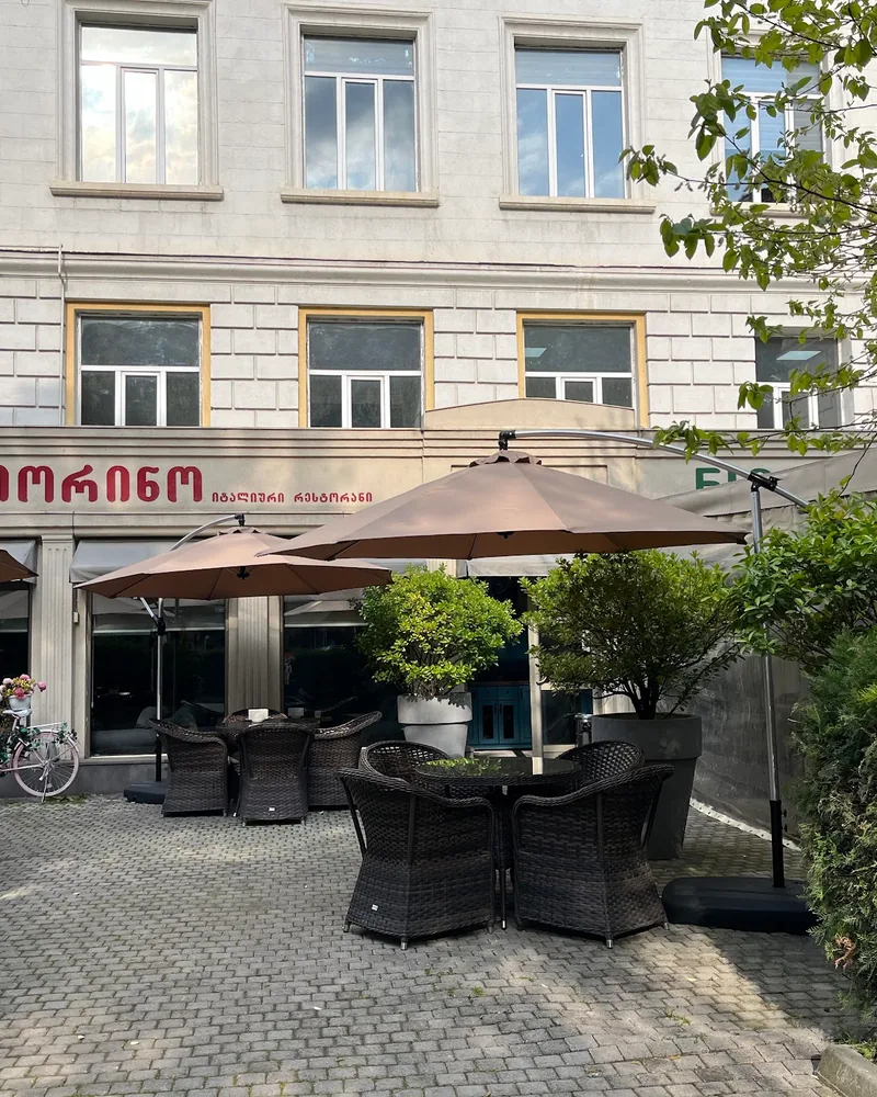 Outdoor patio seating with umbrellas at Fiorino