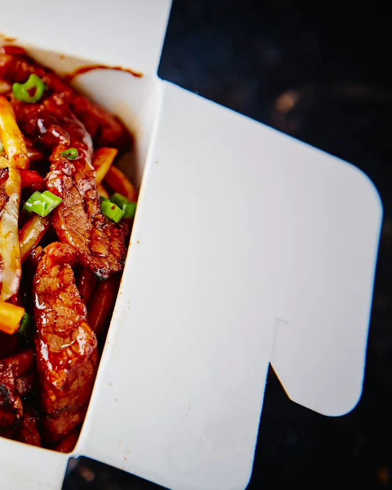 Stir-fried beef noodles in a takeout box at Fire Wok (Dadiani)