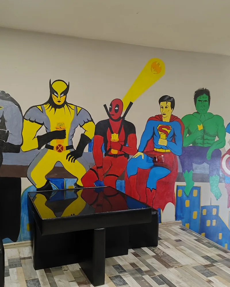 Dining area with superhero wall mural at Flash Shawarma