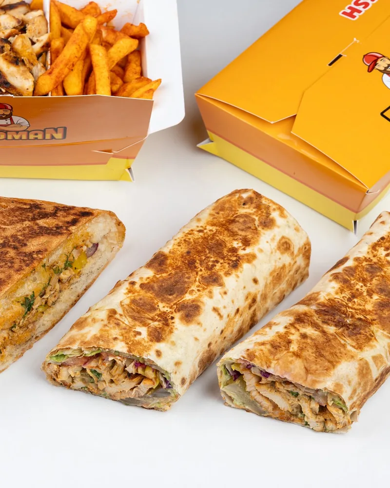 Selection of kebab, sandwich, and shawarma wraps with takeaway box at Foodman