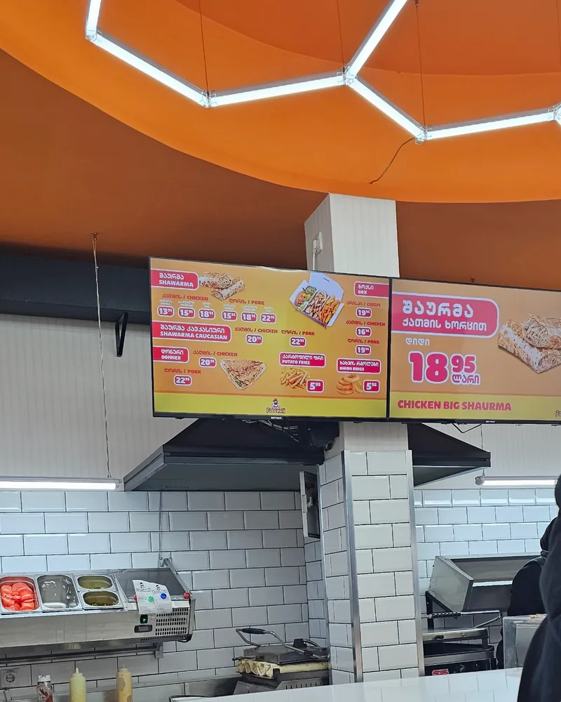 Fast food ordering counter and menu screens at Foodman