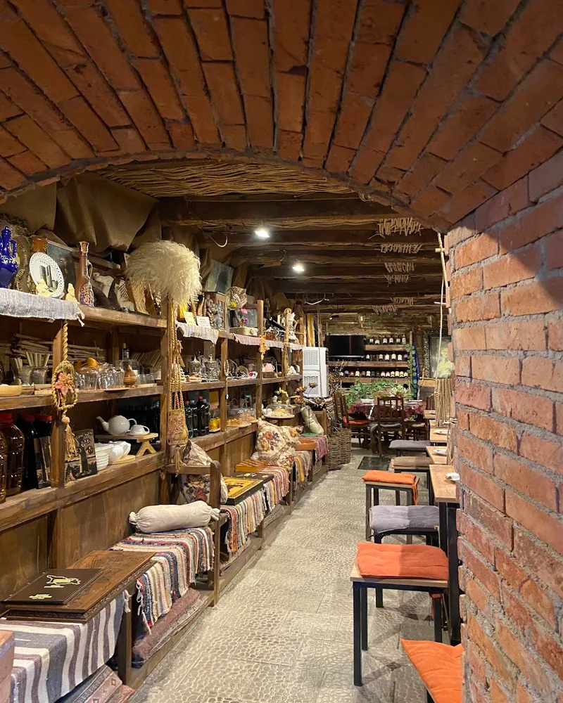 Brick-vaulted rustic dining room with wooden shelving at Friendly Corner
