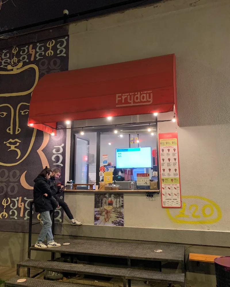 Takeaway window with red awning at Fries & More