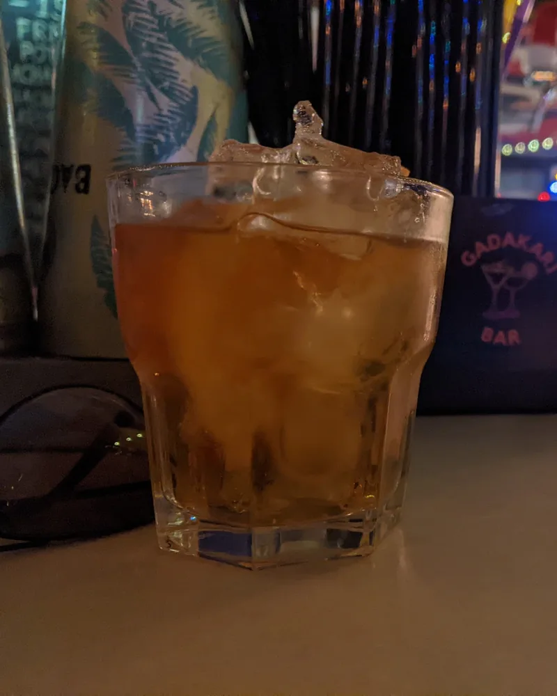 Amber cocktail on the rocks in a lowball glass at Gadakari Bar