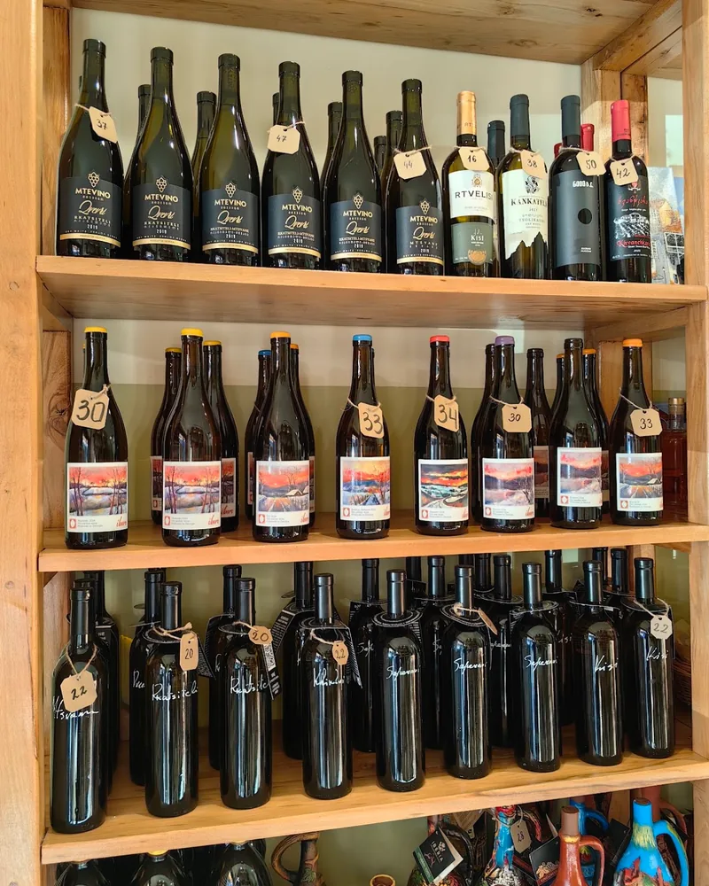 Wooden shelves with bottles of wine at Ge-Wine