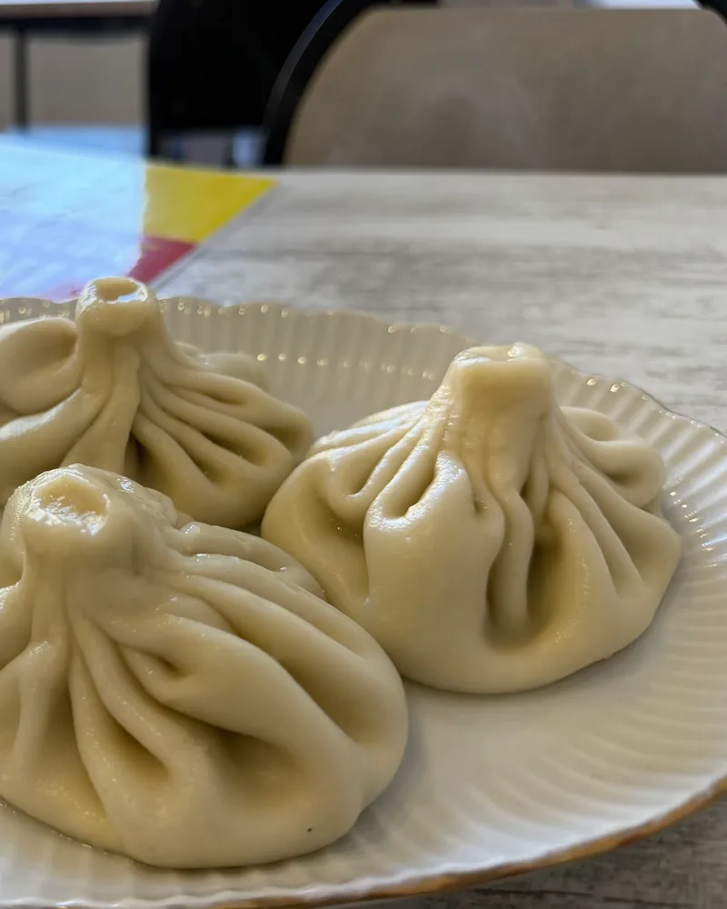 Boiled khinkali dumplings on a fluted plate at Cafe Irioni