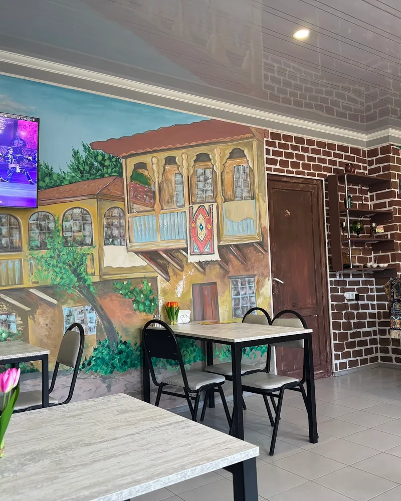 Dining area with mural and tables at Cafe Irioni