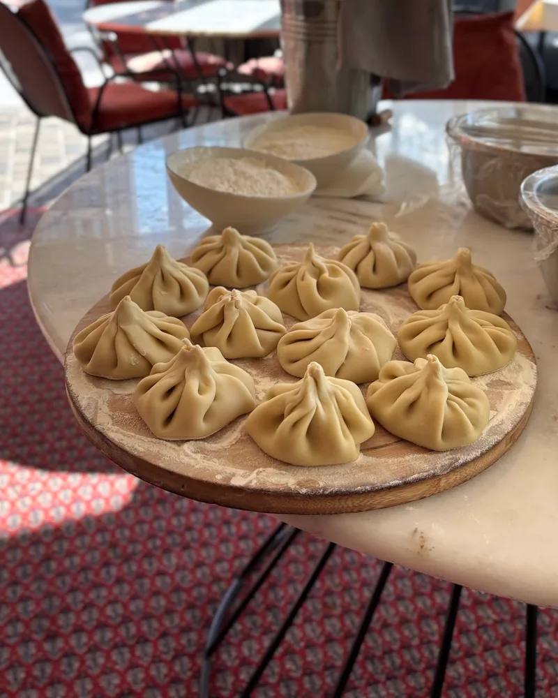 Raw khinkali on a wooden board at Georgian Cooking Class Tbilisi