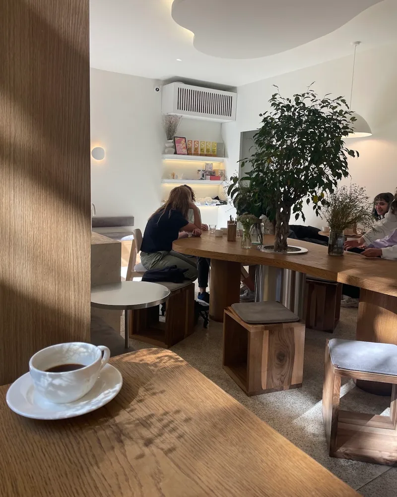 Interior with a wooden communal table and an indoor plant at Chakandrila Cooking Classes