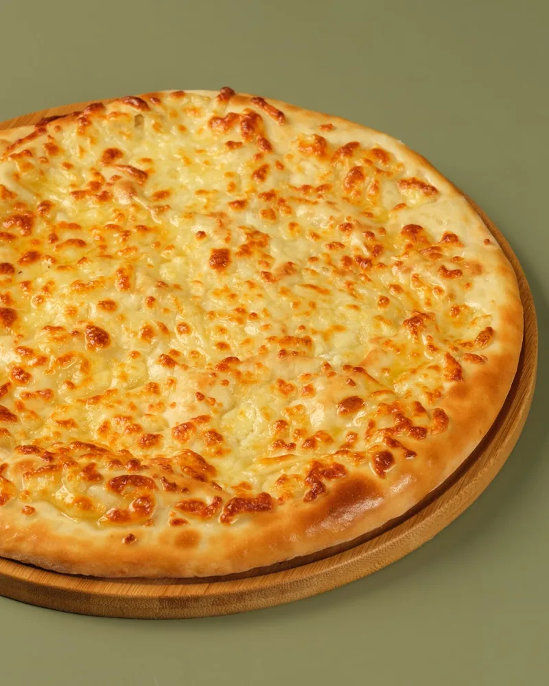 Imeruli khachapuri on a wooden board at Gobi