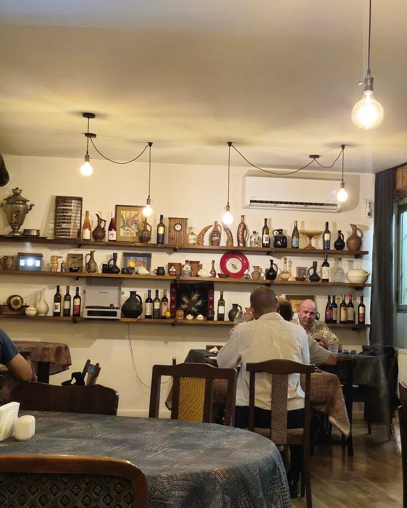 Dining room with shelves of wine and traditional decor at Gobi