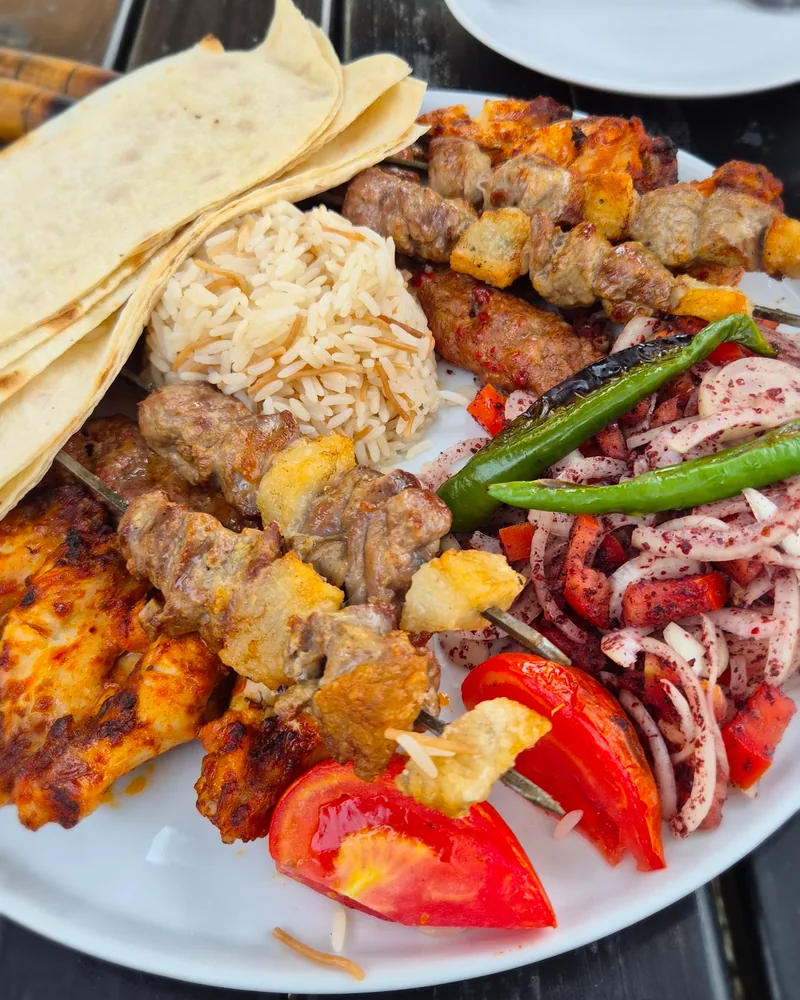 Mixed grill platter with flatbread, rice and onion sumac salad at Golden Moon