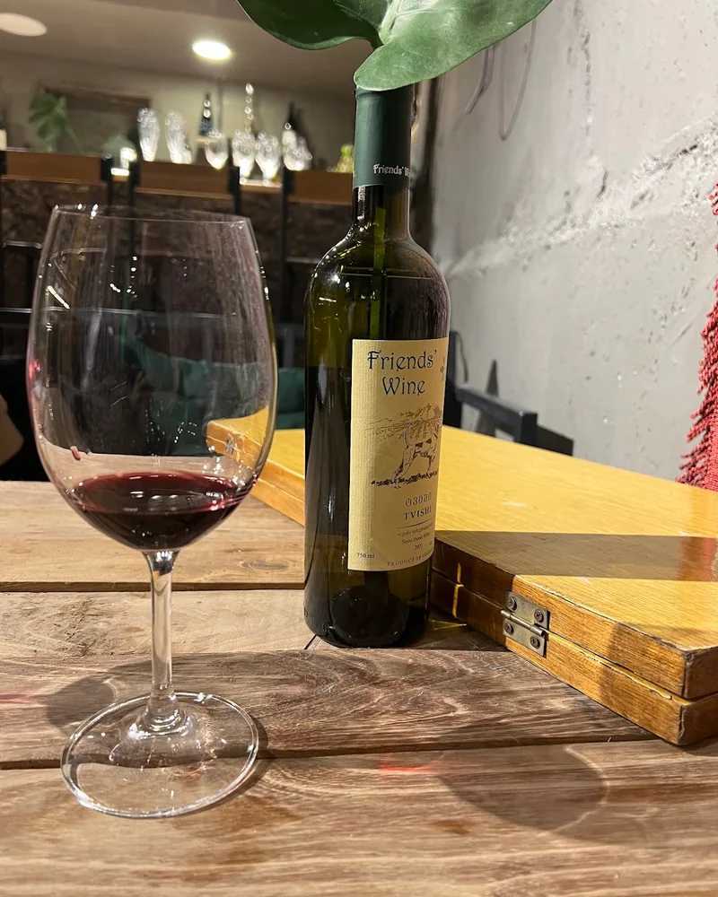 Red wine in a wine glass with bottle at Gvazi Winery