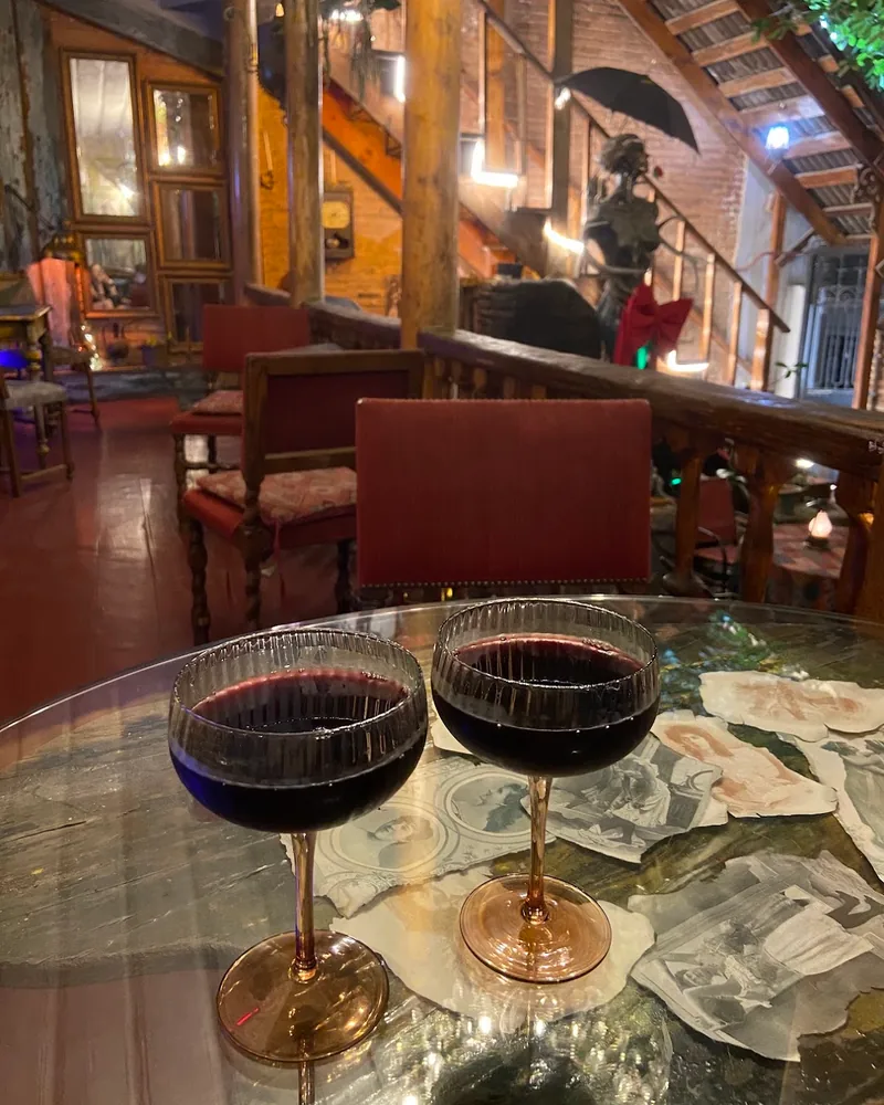 Two glasses of red wine in ribbed coupes at Impulse