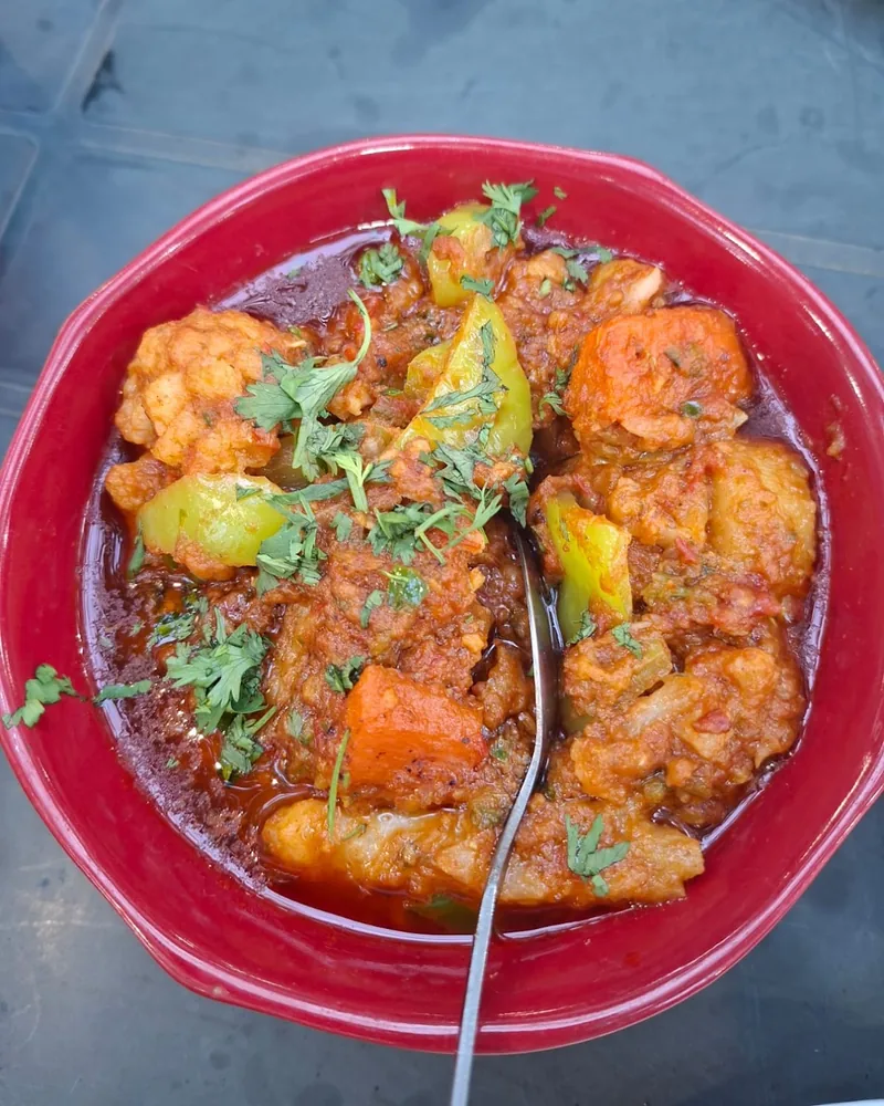 Vegetable curry in a red bowl at Indus Valley