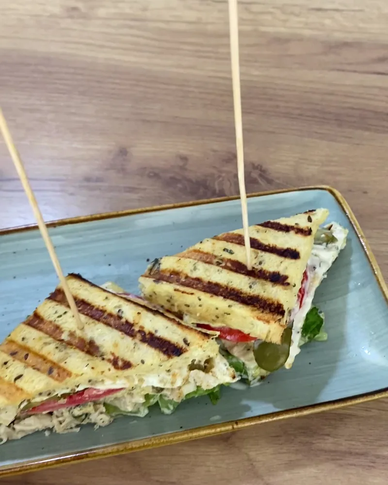 Toasted club sandwiches with skewers on a plate at Indus Valley