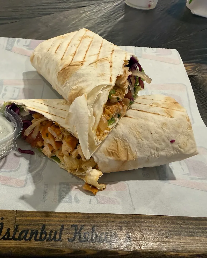 Chicken shawarma wrap cut in half with sauce at Istanbul Kebab’s