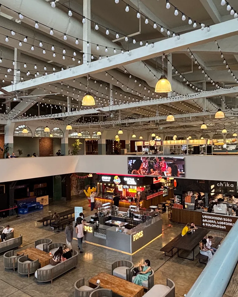 Large food hall atrium with string lights and stalls at Istanbul Kebab’s