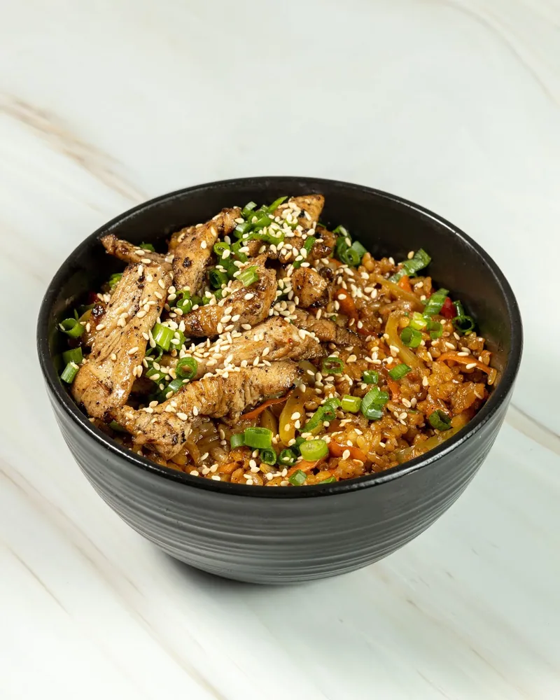 Chicken fried rice bowl with sesame seeds and scallions at iSushi