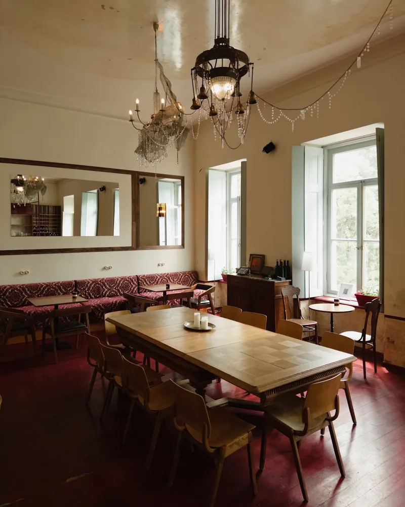 Dining room with wooden table and chandeliers at Italian Pasta