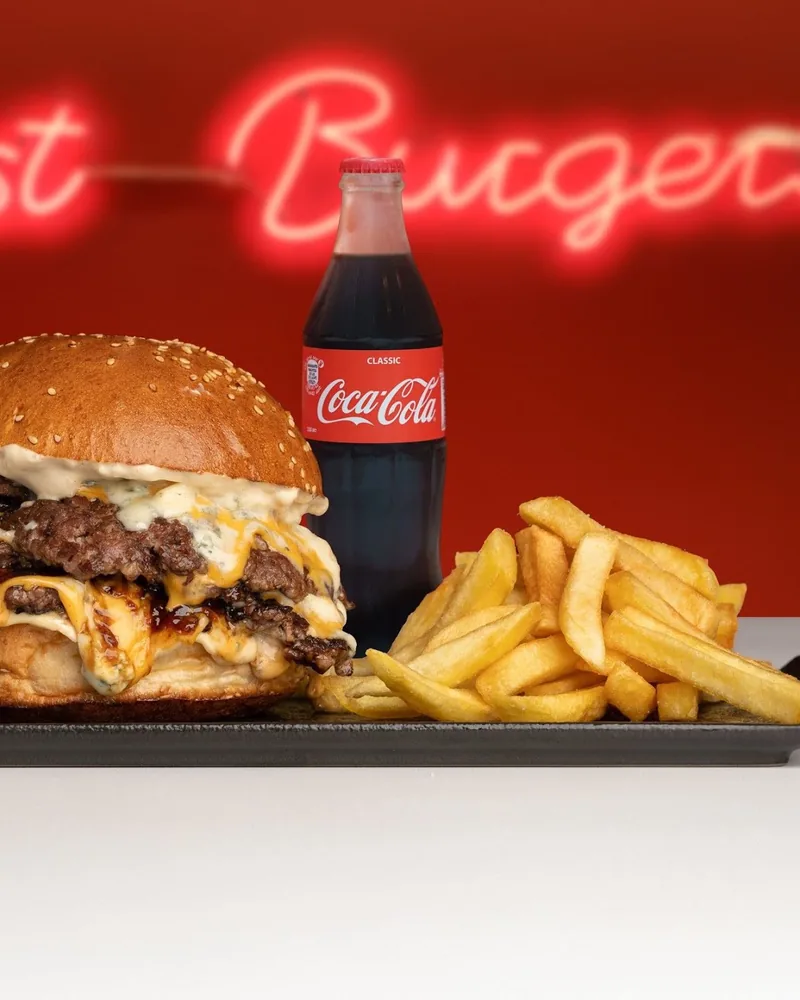 Double cheeseburger with fries and a bottle of cola at Just Burgers