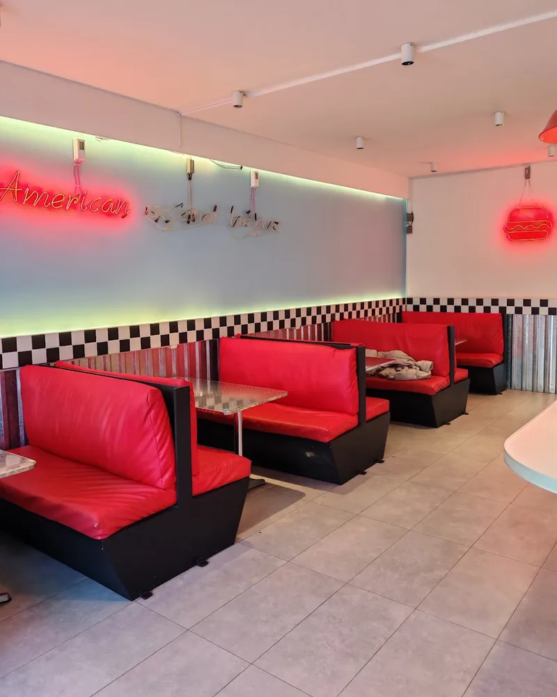 Diner seating with red vinyl booths at Just Burgers