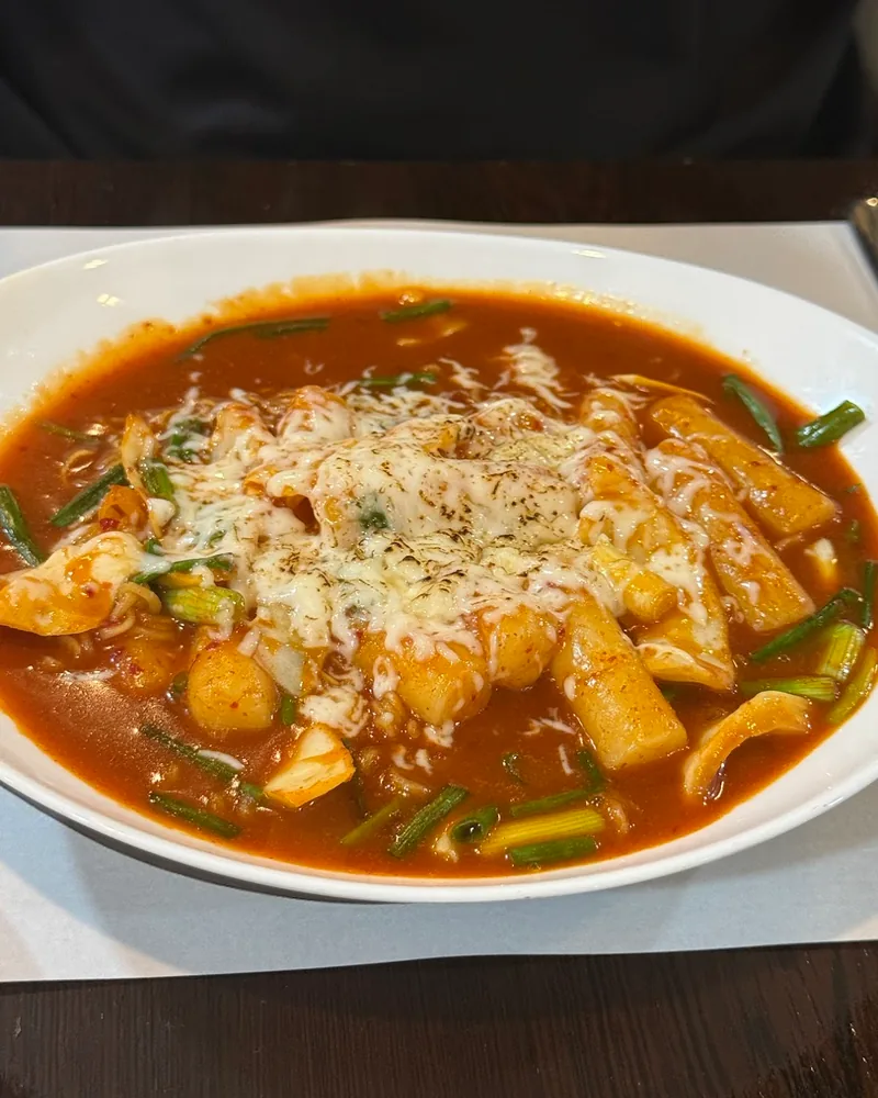 Cheese tteokbokki in a spicy red sauce at K-Restaurant