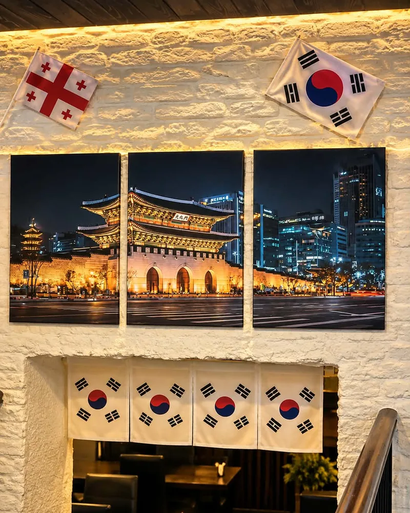 Wall decor with Korean artwork and flags above the dining area at K-Restaurant