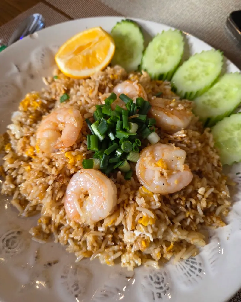 Shrimp fried rice garnished with scallions, cucumber, and lemon at KaPaoBox