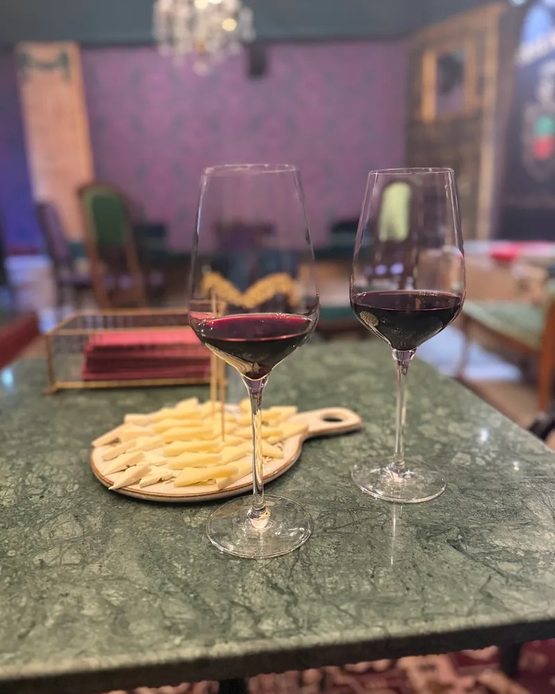 Two glasses of red wine with a cheese board at Karalashvili Wine Cellar
