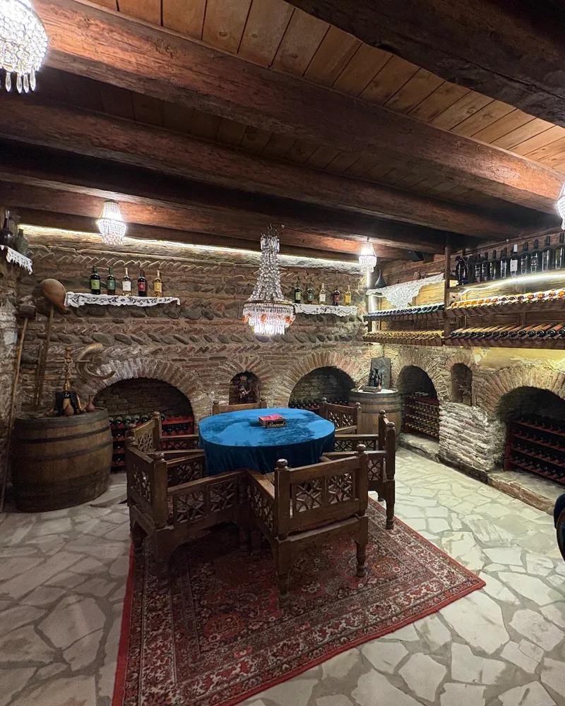Wine cellar tasting room with brick arches and chandeliers at Karalashvili Wine Cellar
