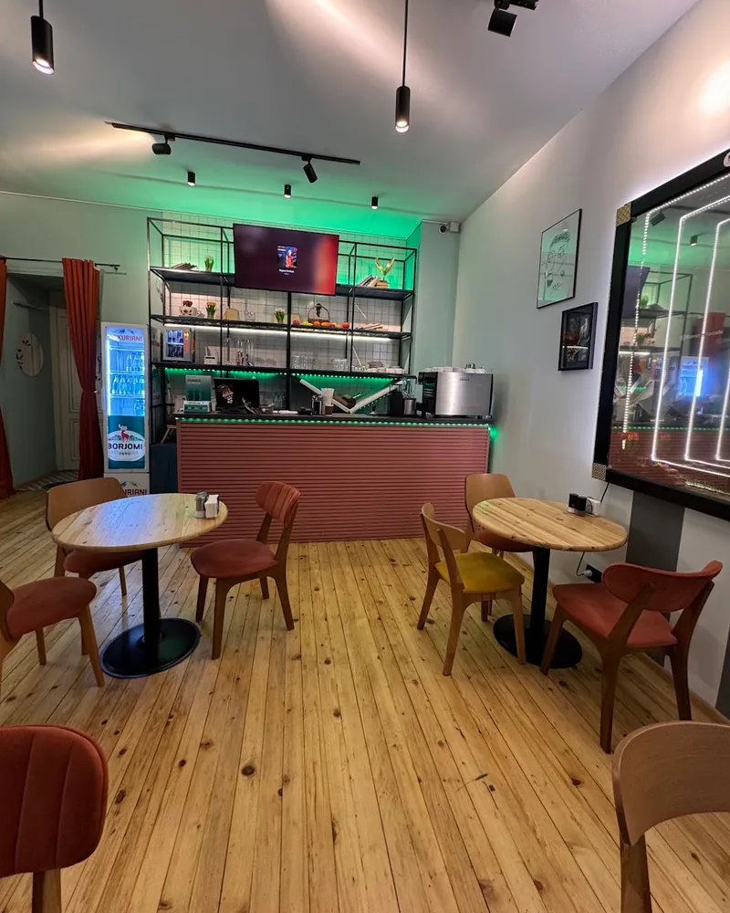 Dining area with wooden tables and counter at Kava Lebanese Restaurant