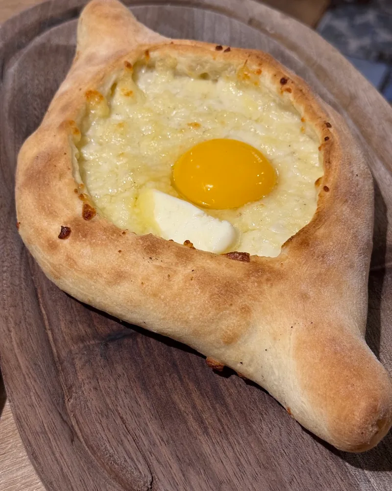 Adjarian khachapuri with egg and butter at Khinkali Bar N1