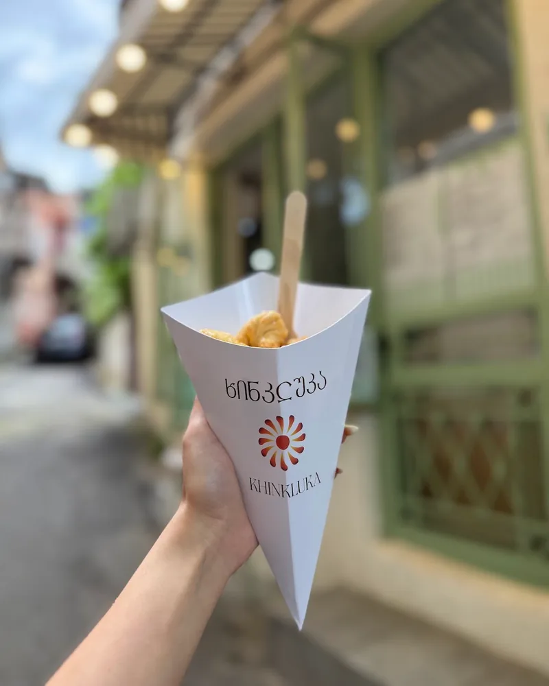 Fried khinkali in a paper cone at Khinkluka