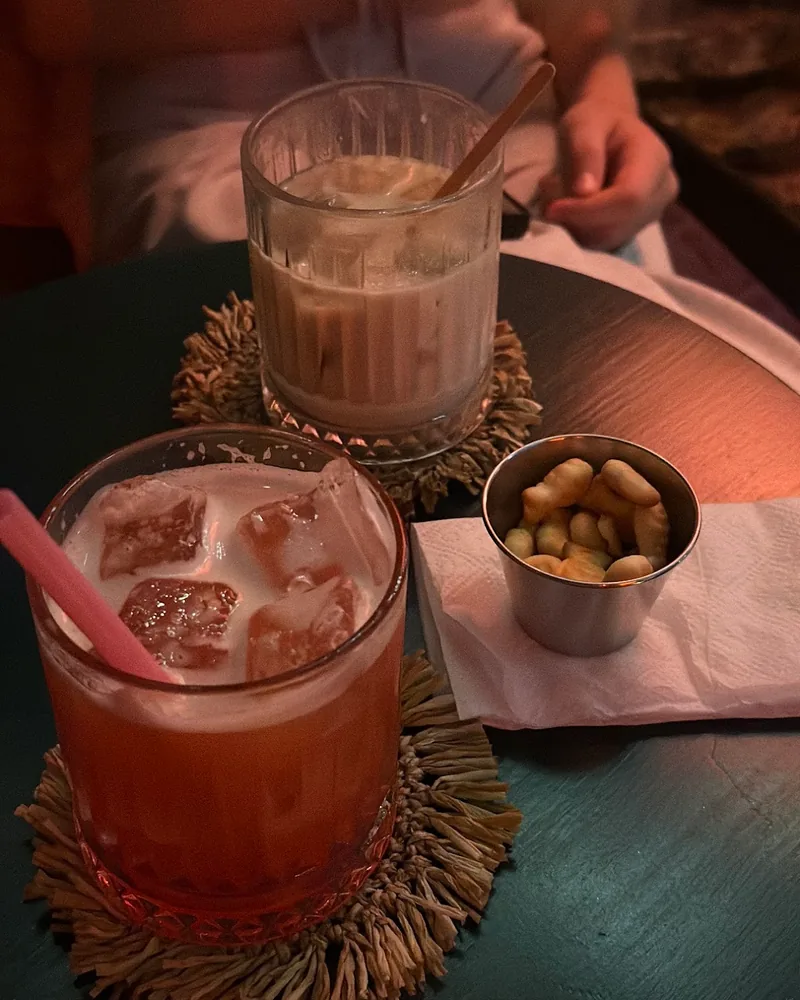 Cocktails and snack on coasters at Kiki Bar