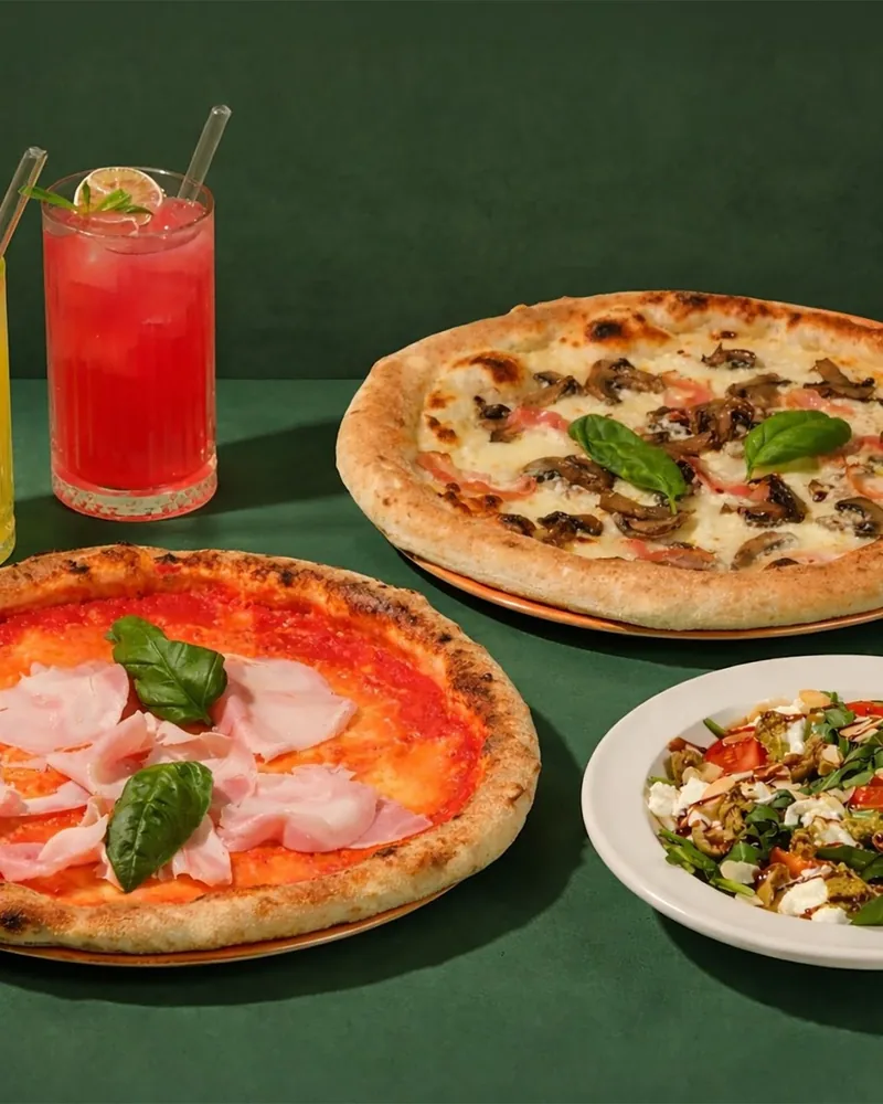 Pizzas, drinks, and salad spread at La Gamba