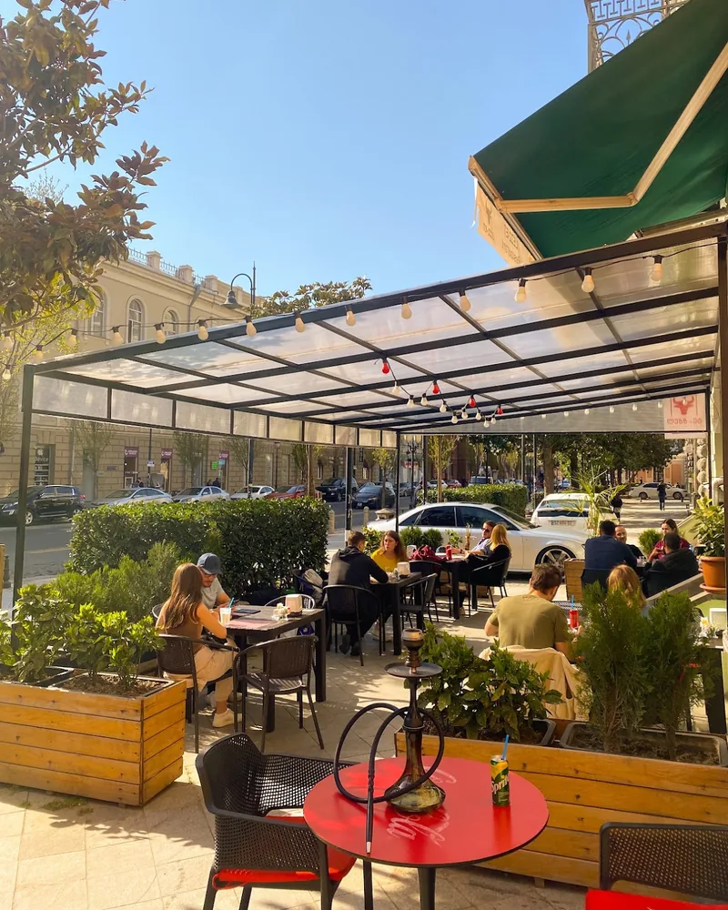 Covered pavement terrace with seating at Lezz-Et
